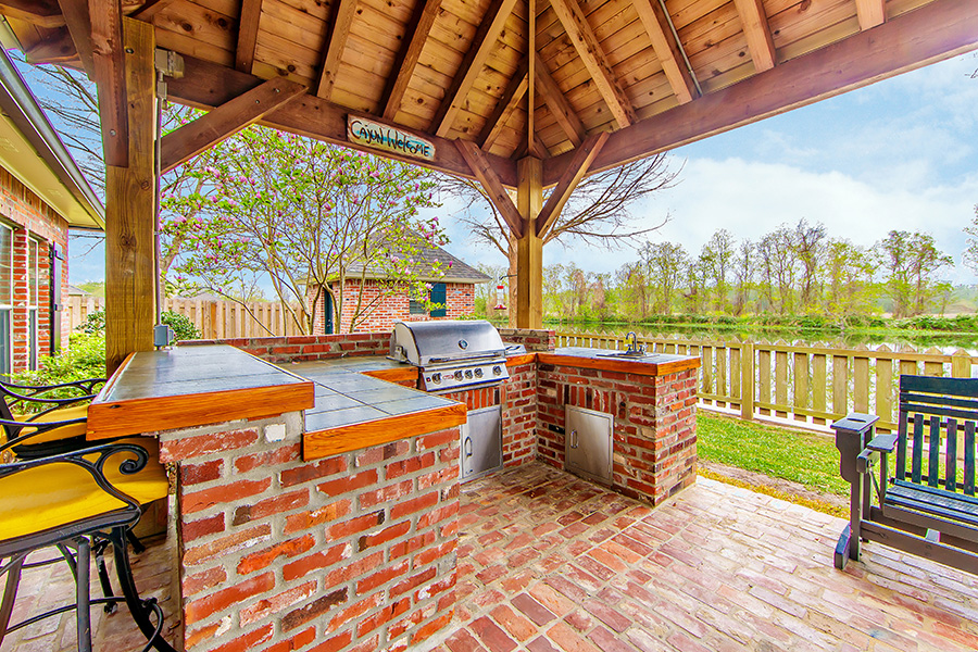 Outdoor brick kitchen in backyard, with wooden canopy overhead - Lebanon, IL