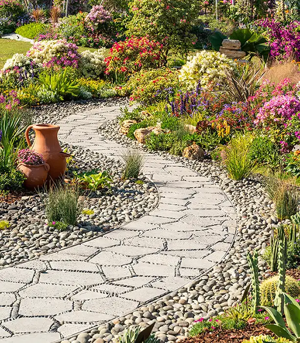 Variety of landscaping elements to create cute walking path - rock garden, paver walkway, sidewalk, flowers - Lebanon, IL